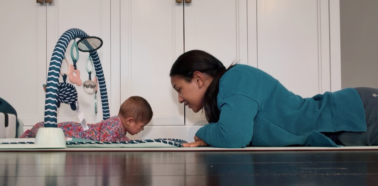 Peterlyn doing tummy time with a baby