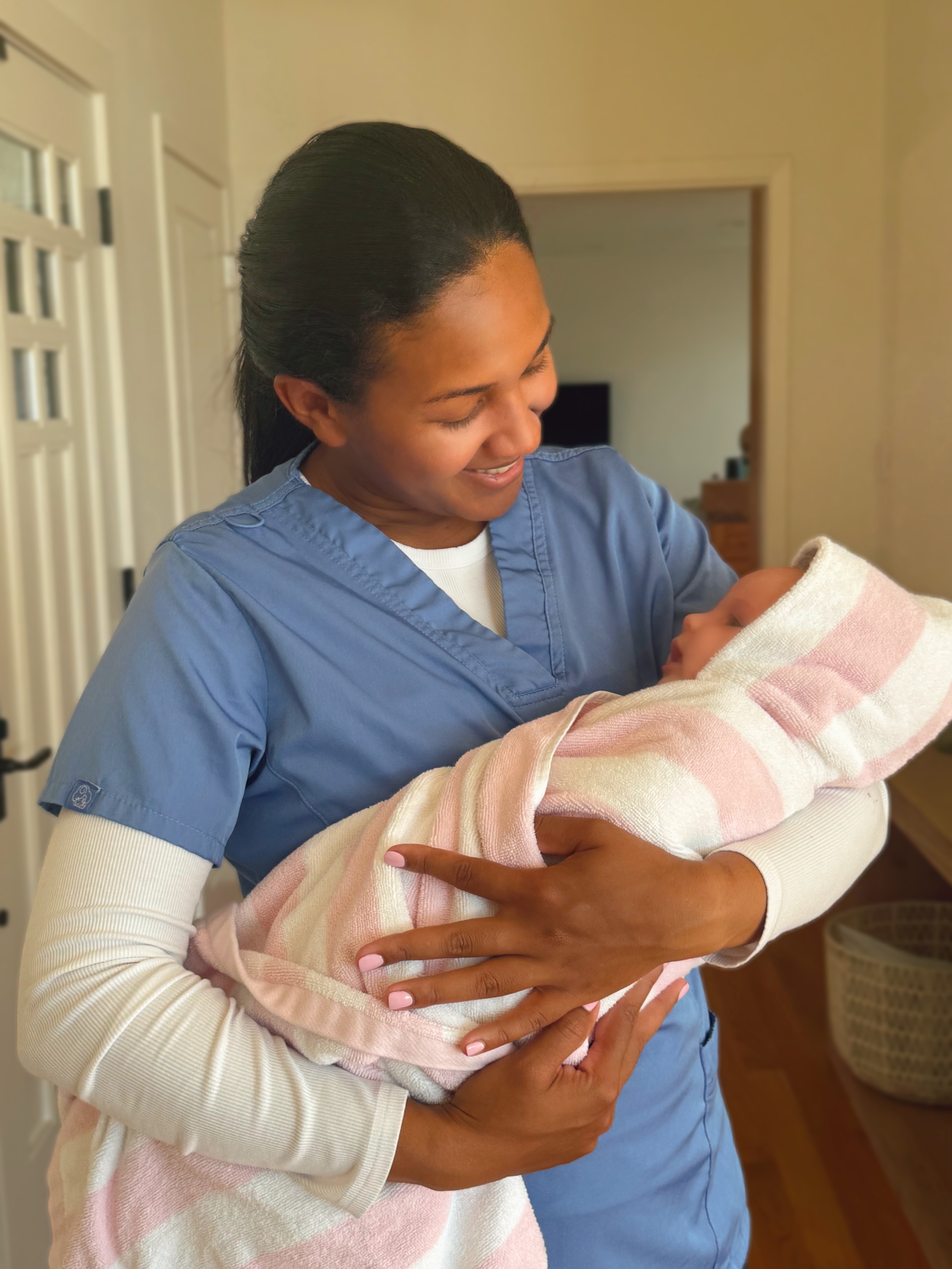 Peterlyn with a swaddled newborn