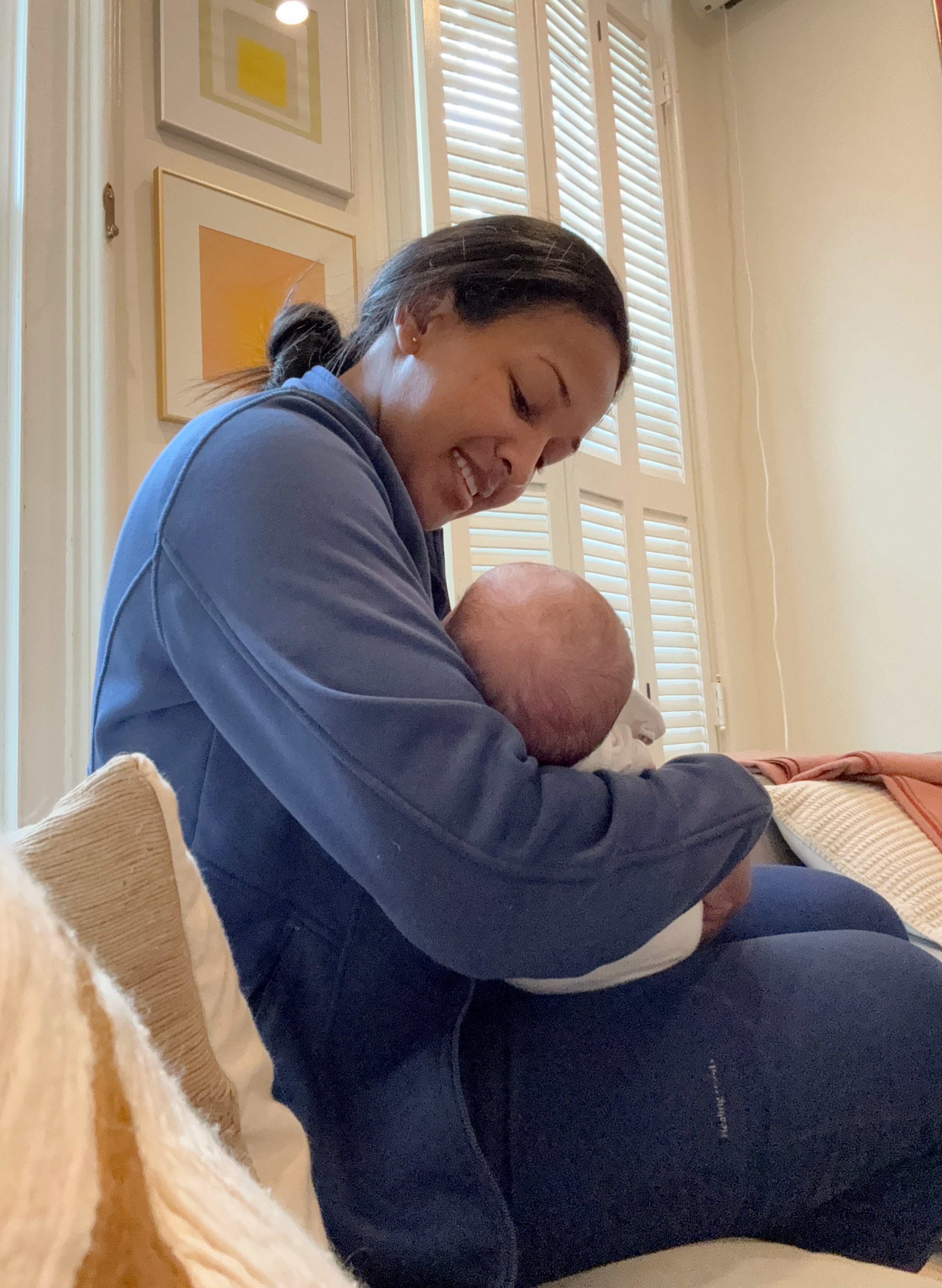 Peterlyn gently holding a newborn